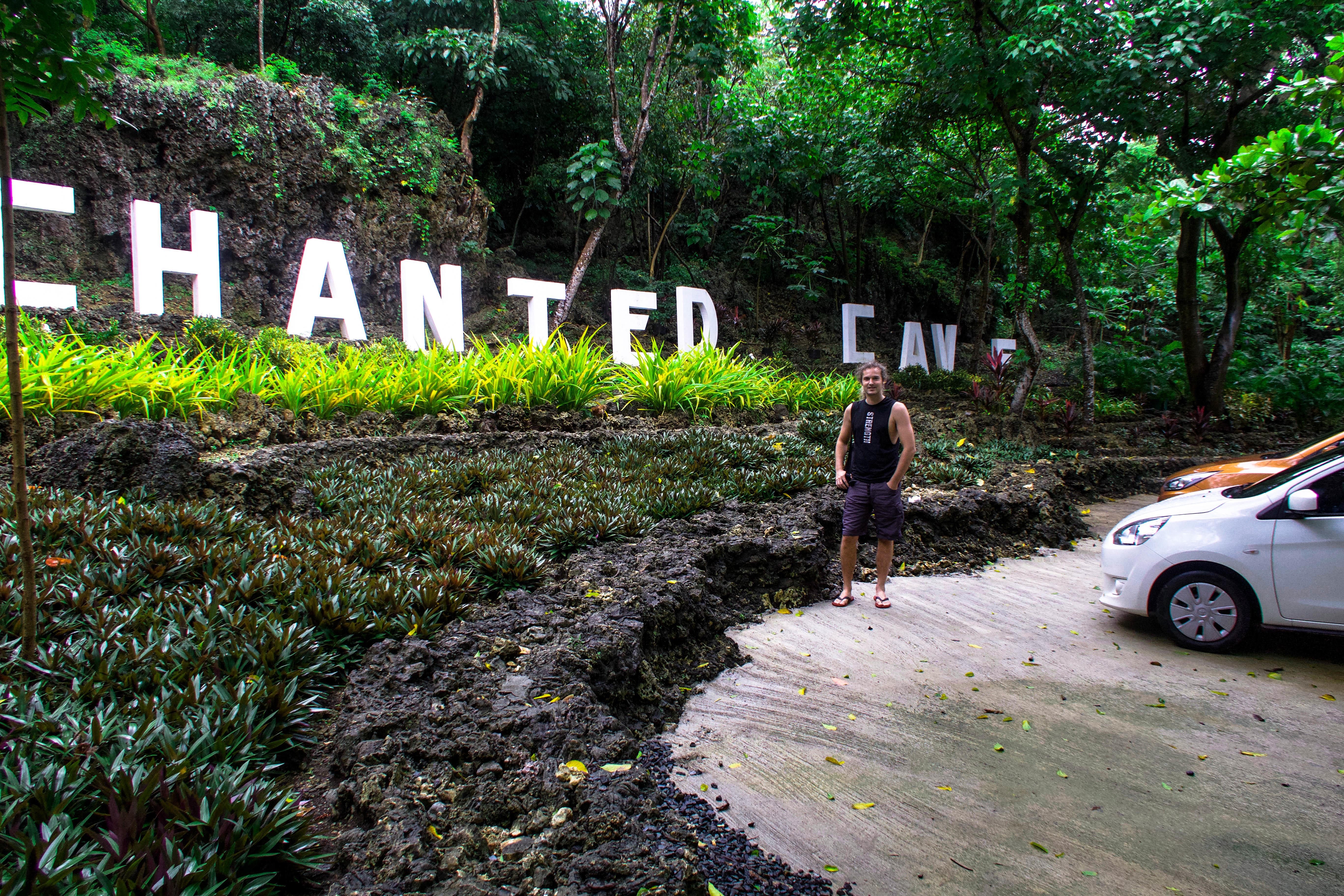 lenny through paradise with big letters of the white sign of enchanted cave bolinao pangasinan philippines